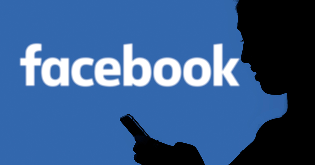 facebook logo with silhouette of person holding phone