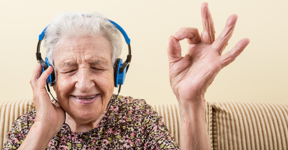 Elderly woman wearing headphones and enjoying some music
