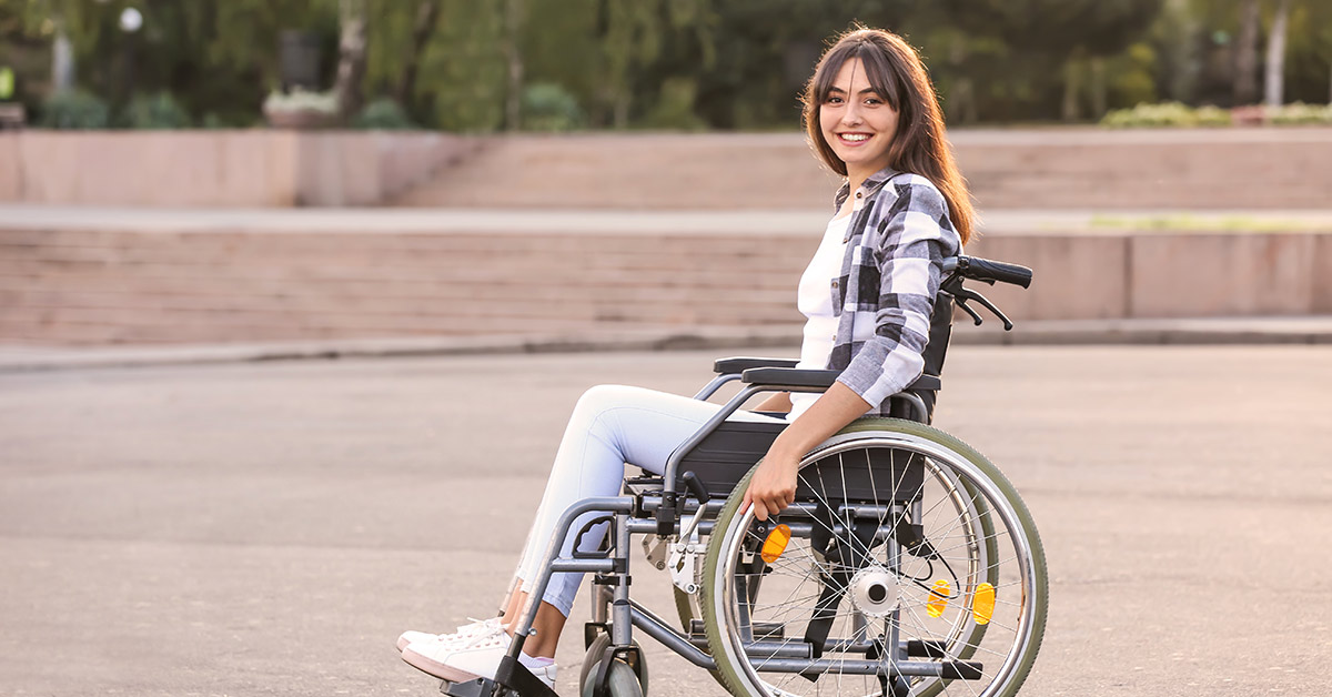 young woman smiling in wheel chair