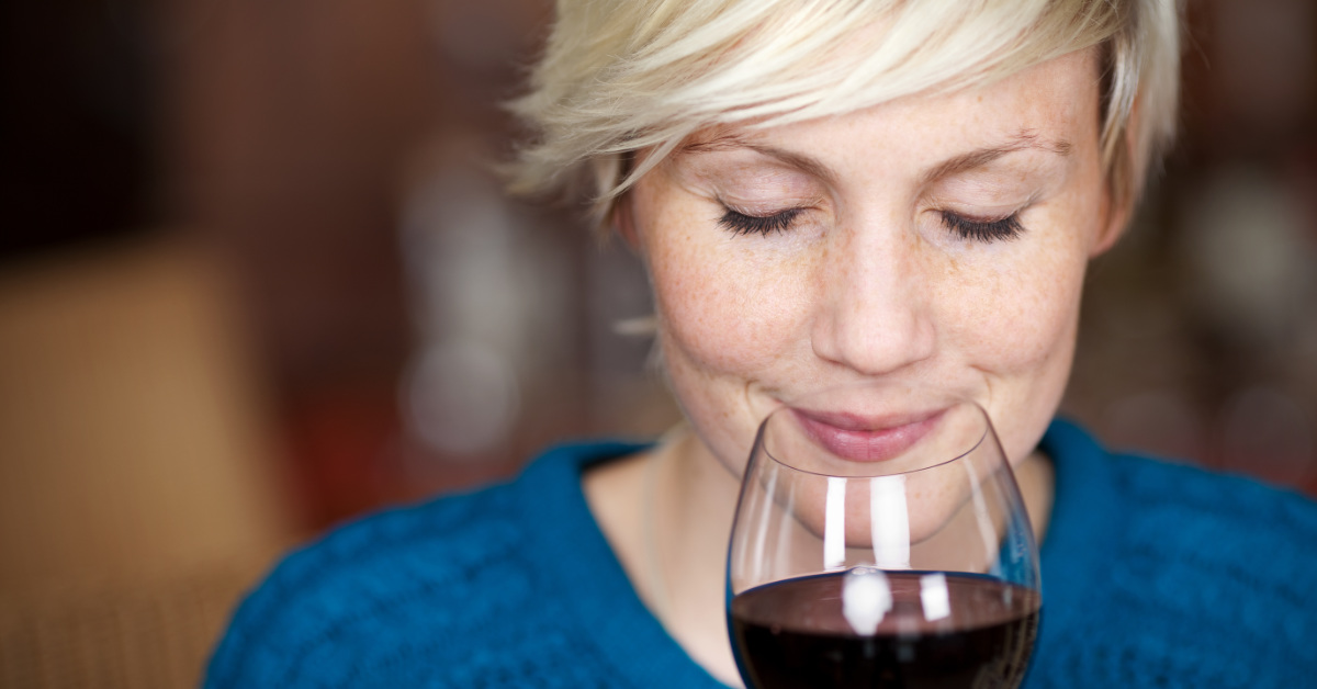 woman smelling wine