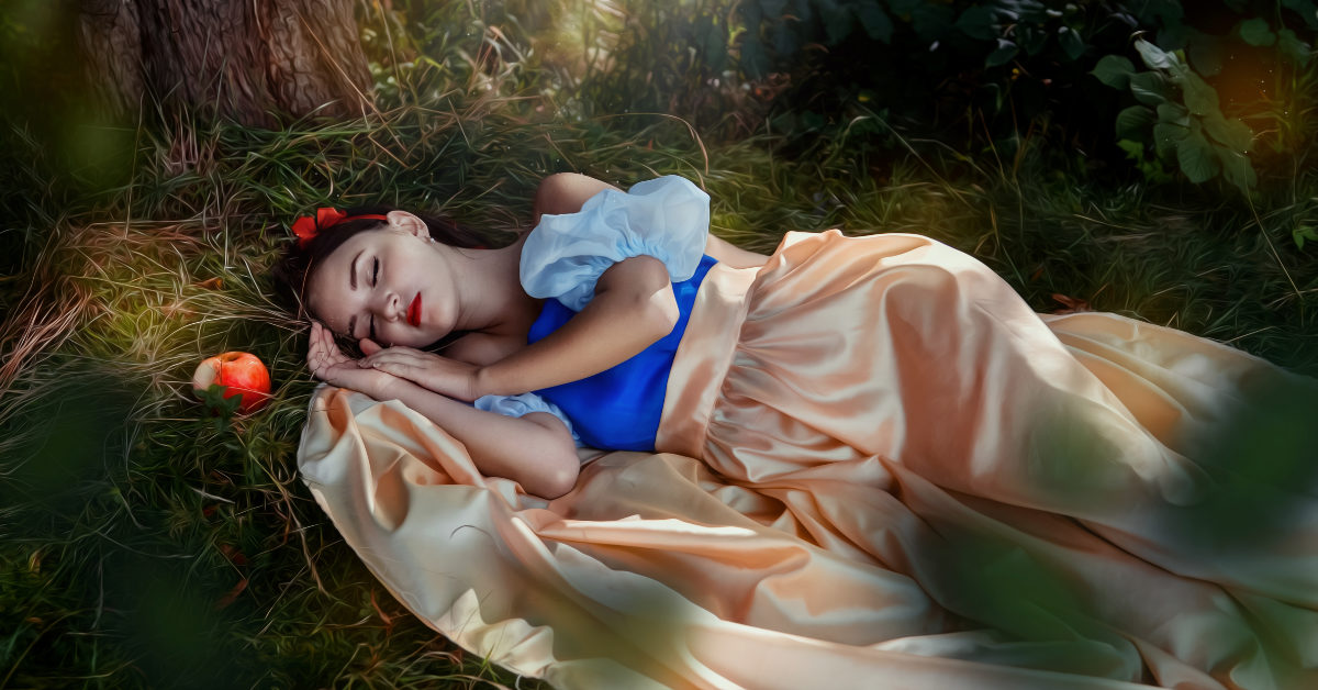 Snow White asleep in the grass beneath a tree