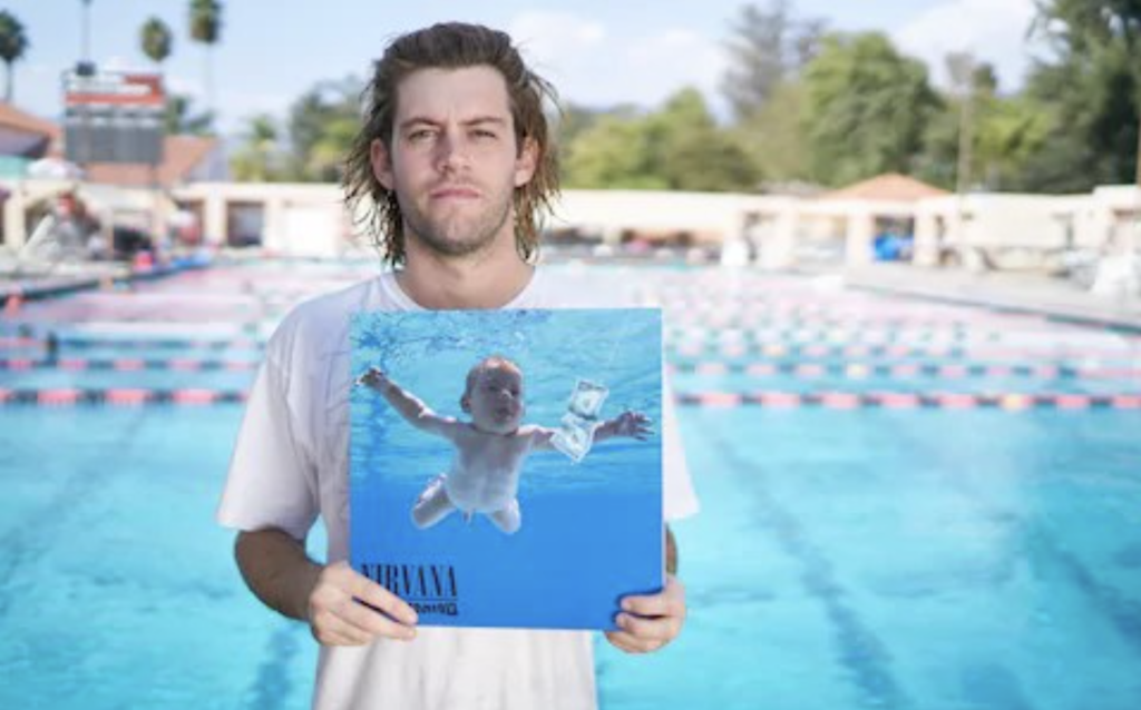 Spencer Elden holding the record Nevermind by Nirvana. 