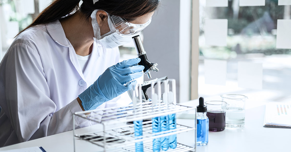 scientist using microscope