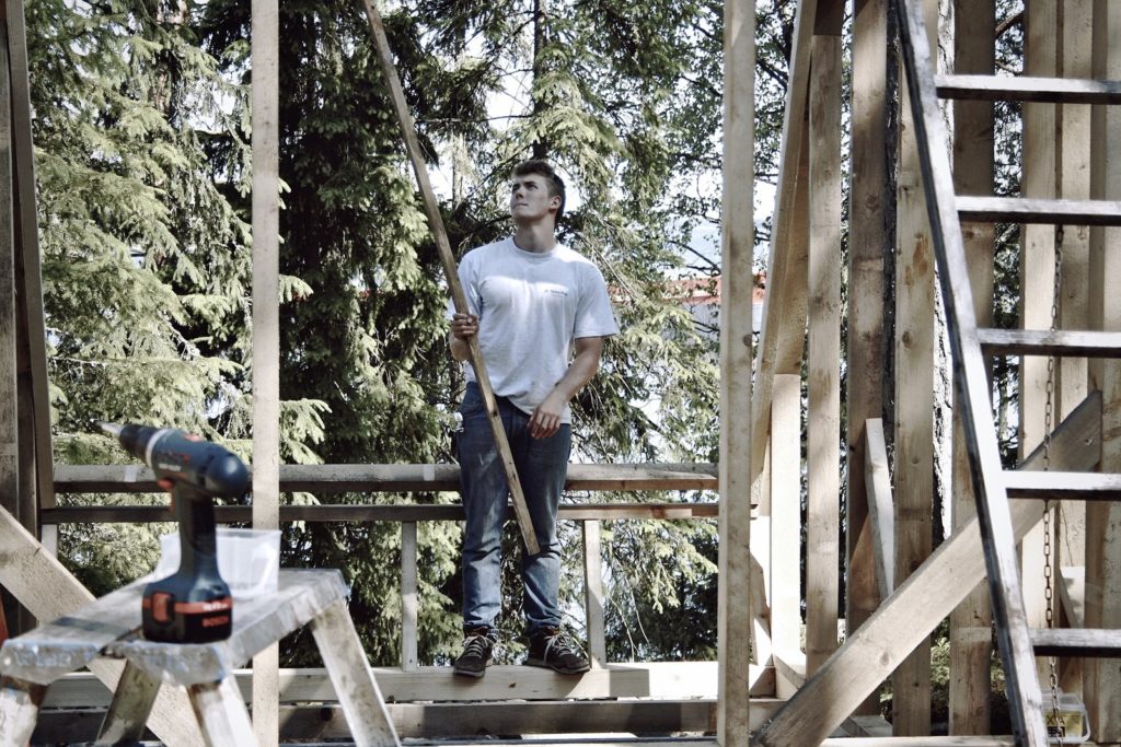 A worker building the cabin