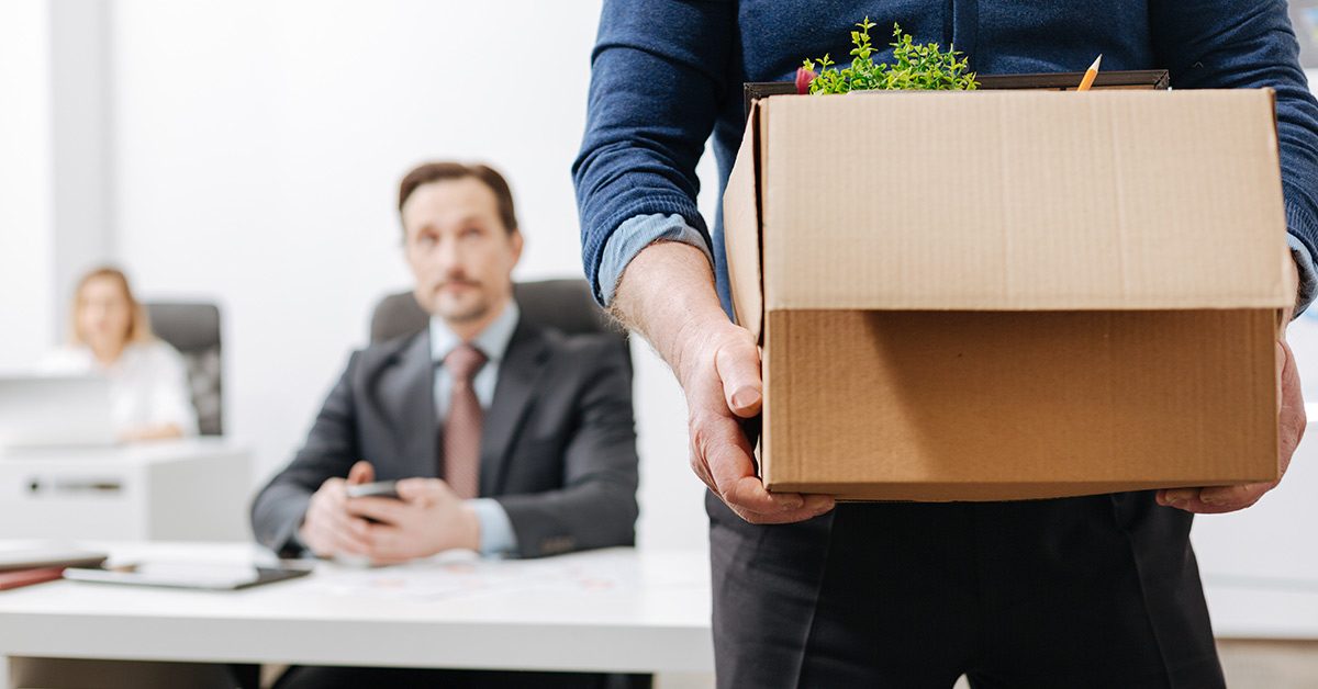 employee leaving with personal items in a box after quitting