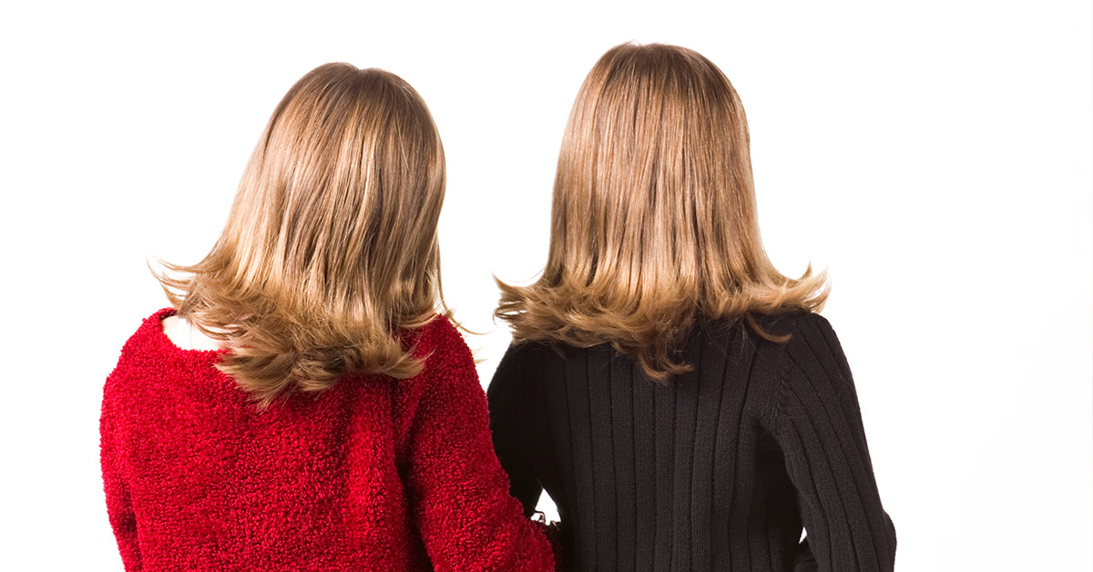 two women with similar hair styles facing away f