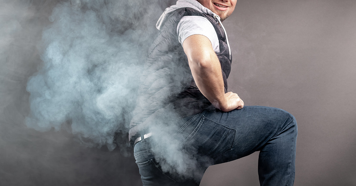 man with steam emanating from his pants which gives the appearance of flatulence