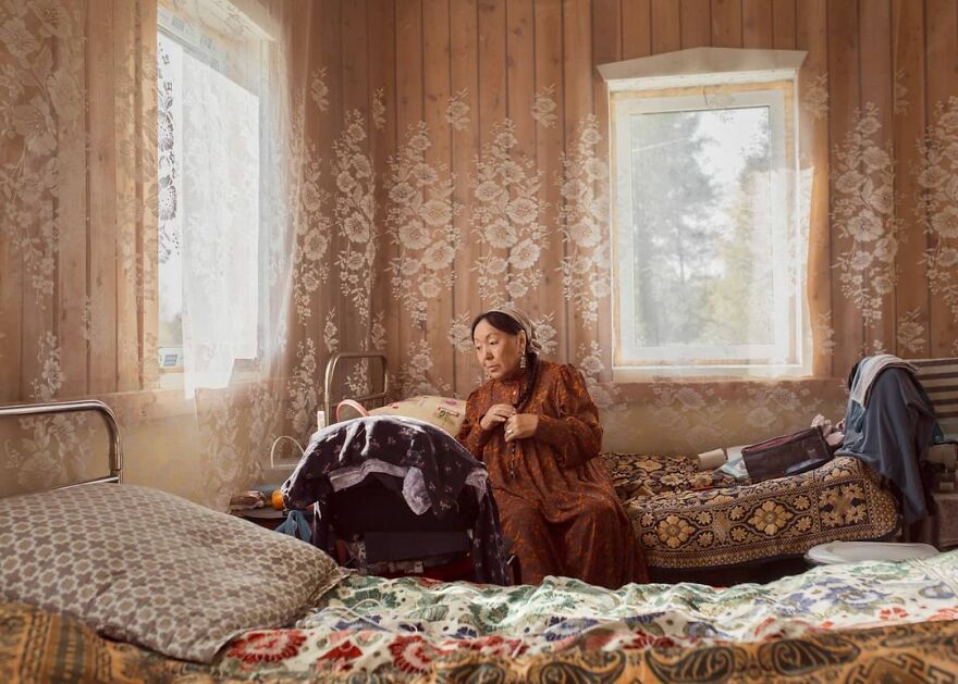 Woman sitting on a bed. Photo by Aleksey Vasiliev