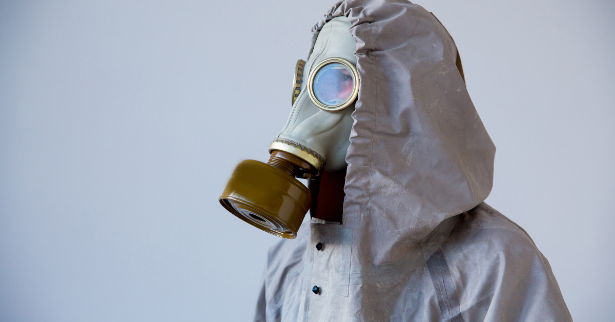 person in gas mask and nuclear fallout suit