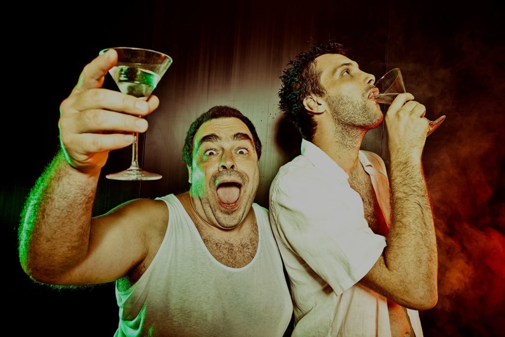 two men partying drinking martinis 