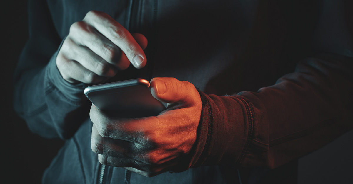 person using smartphone in dark area