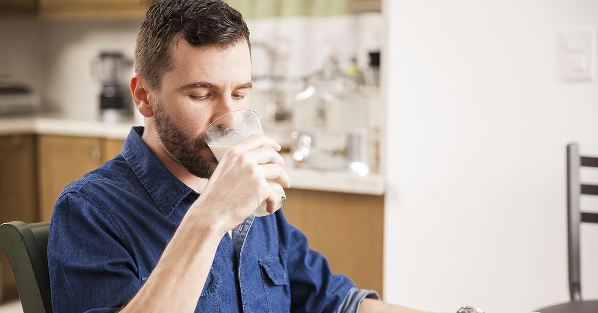 man drinking a glass of milk