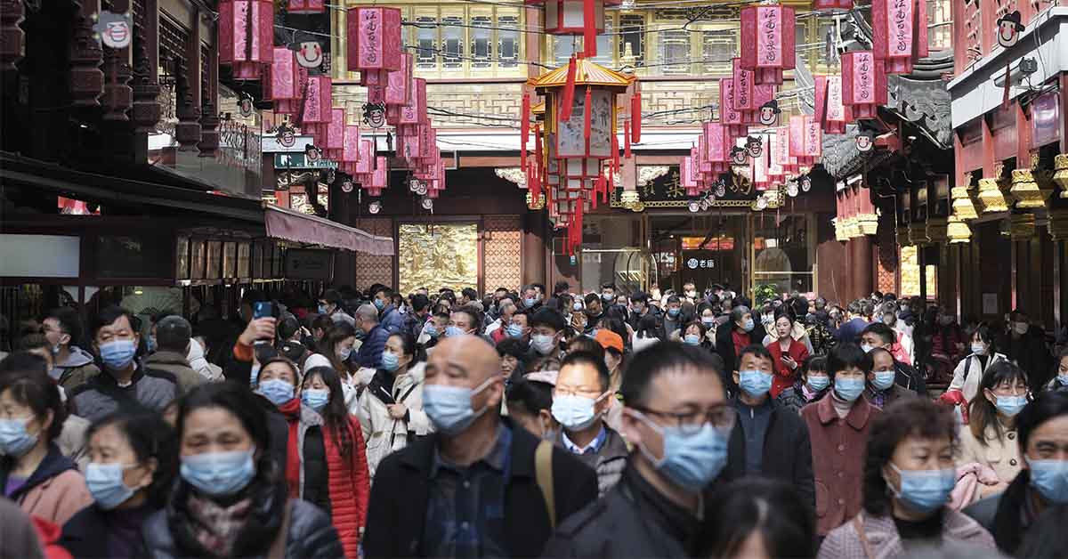 Group of people walking through market in China