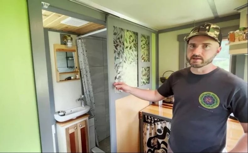 Nick Soave showing his bathroom in his tiny house