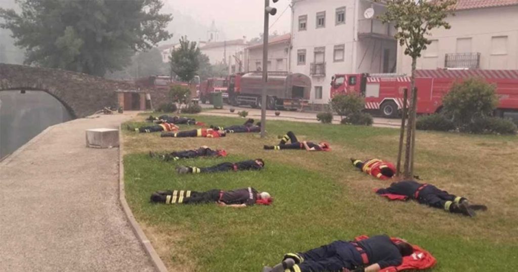 Photo of firefighters laying across the lawn went viral