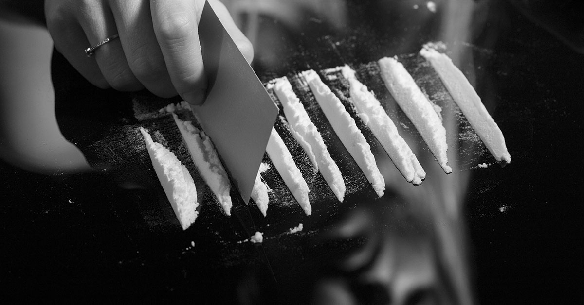 cocaine being separated into lines with a card