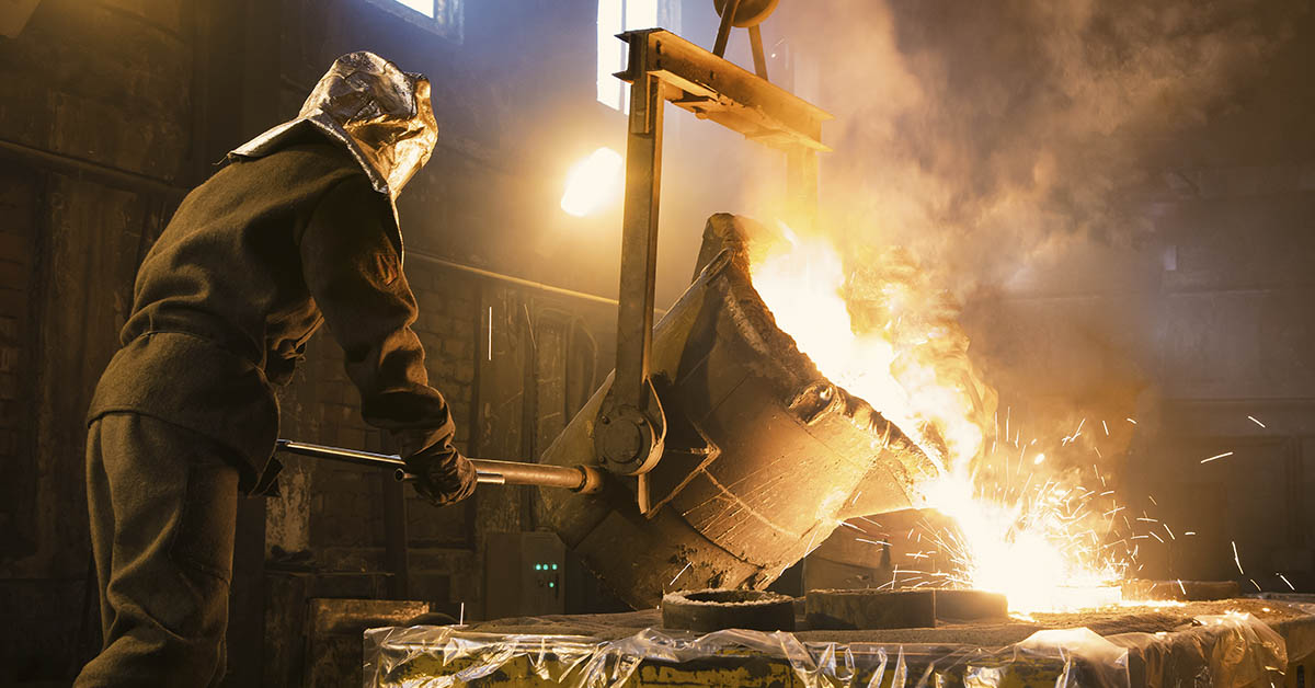 foundry worker pouring molten metal