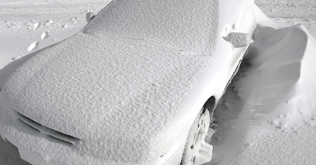 car covered in snow from blizzard