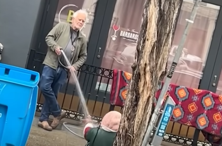 Man Sprays Homeless Woman