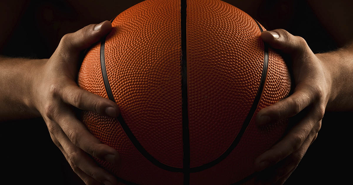 basketball being held by two hands