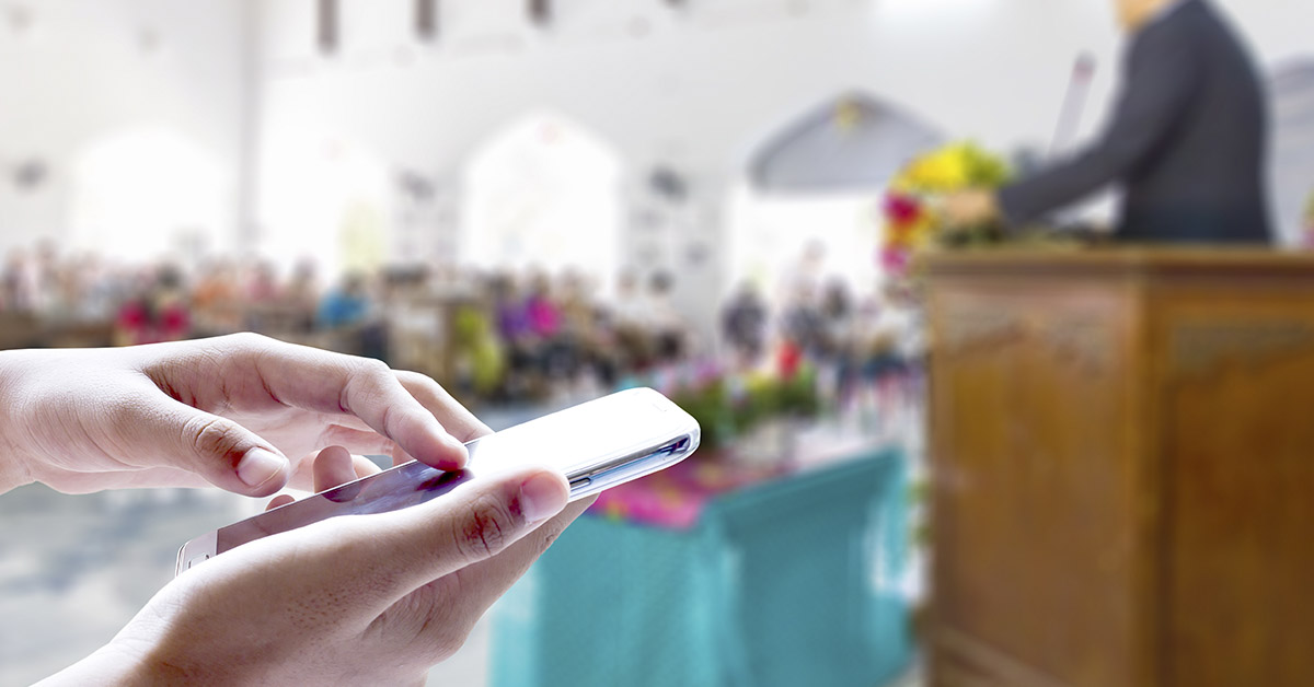 Girl use mobile phone, blur image of activity in the Church as background.
