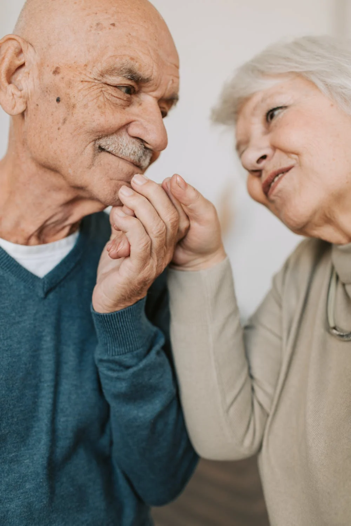 An elderly couple holding hands