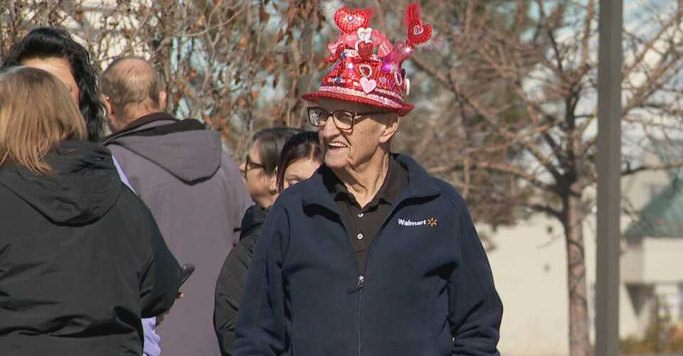 Walmart greeter, Thane Telford in a funky hat