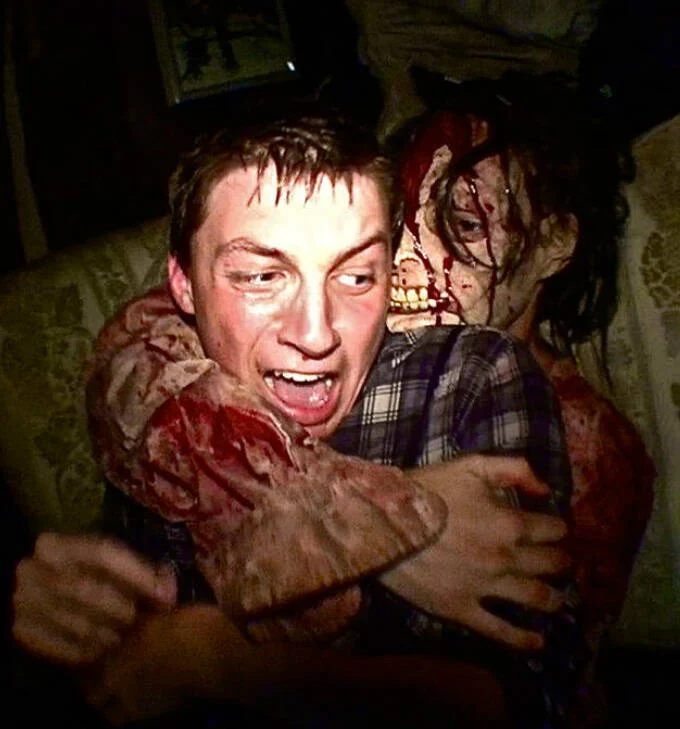 customer of McKamey Manor interacting with an actor portraying a zombie 