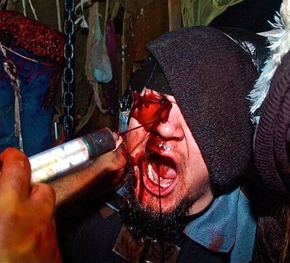customer of McKamey Manor with fake blood being squirt in his face 