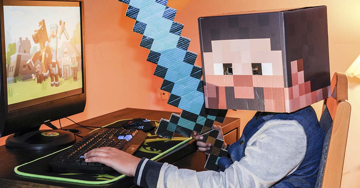 person dressed as Minecraft character playing it on PC