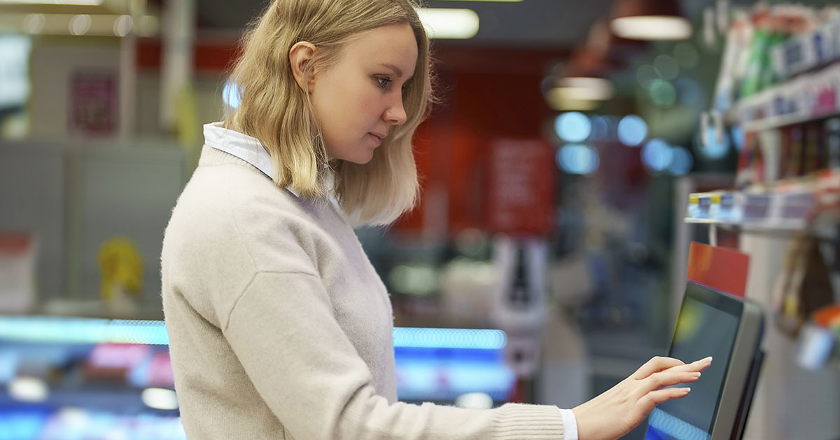 woman using automated checkout machines