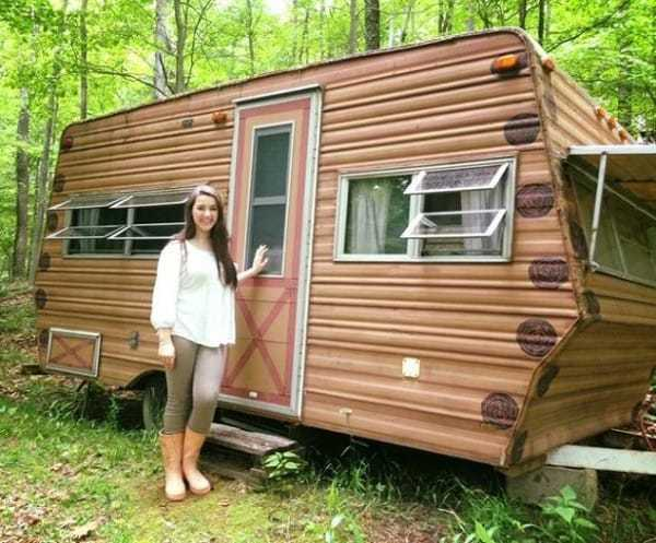 girl standing next to camper
