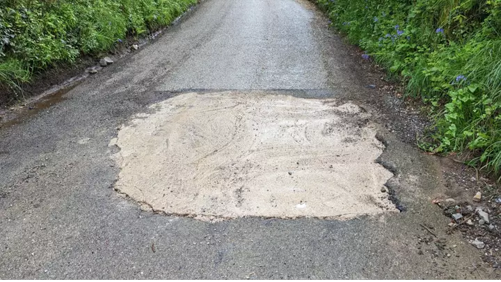The pothole that has been fixed by a private motorist.