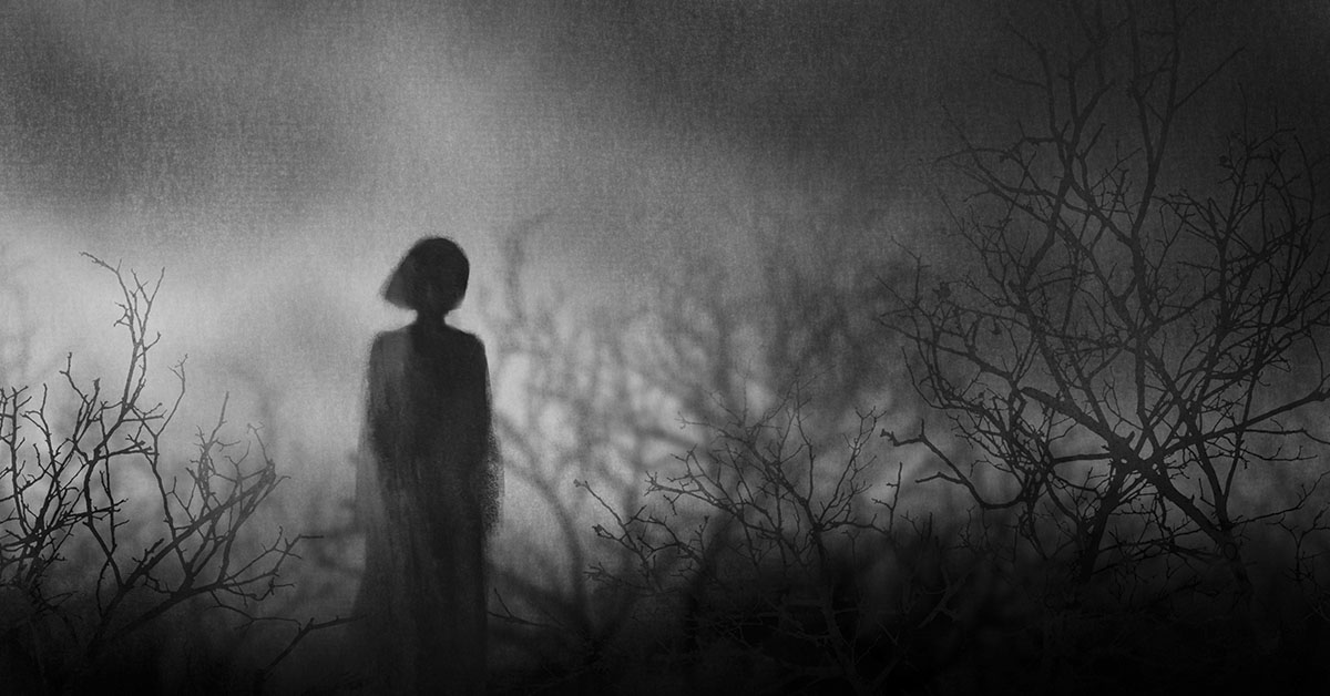 eerie photo of woman walking amongst dead shadows of trees