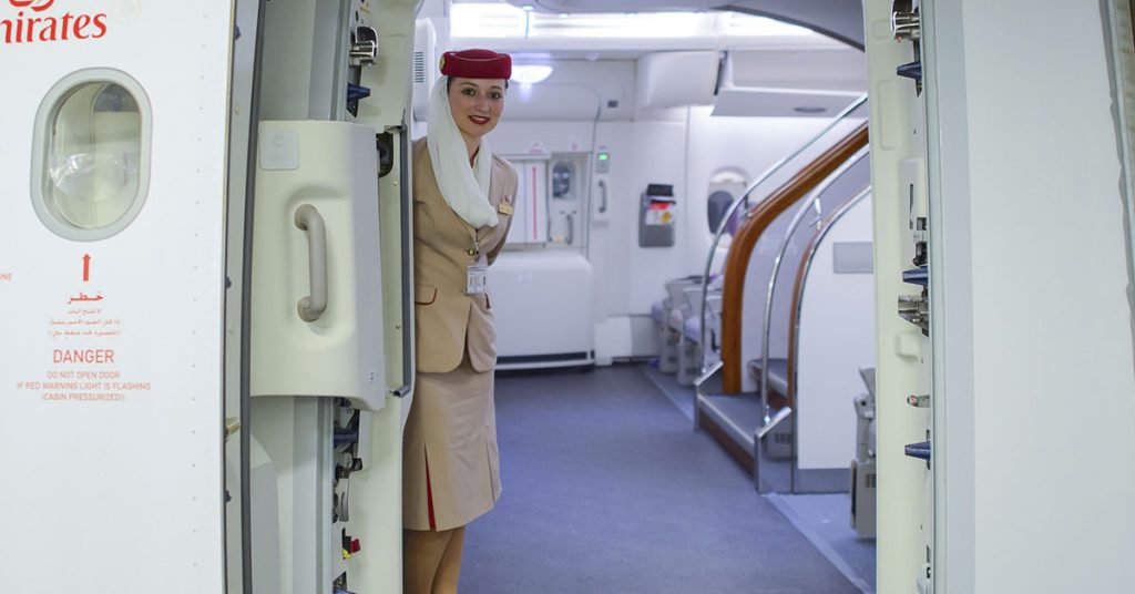 This is Why the Cabin Crew Keeps Their Arms Behind Their Backs When Greeting You - Featured image