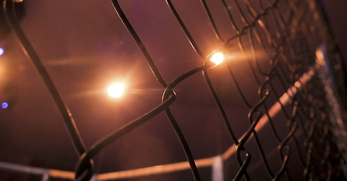 close up of chain link surrounding cage fighting ring