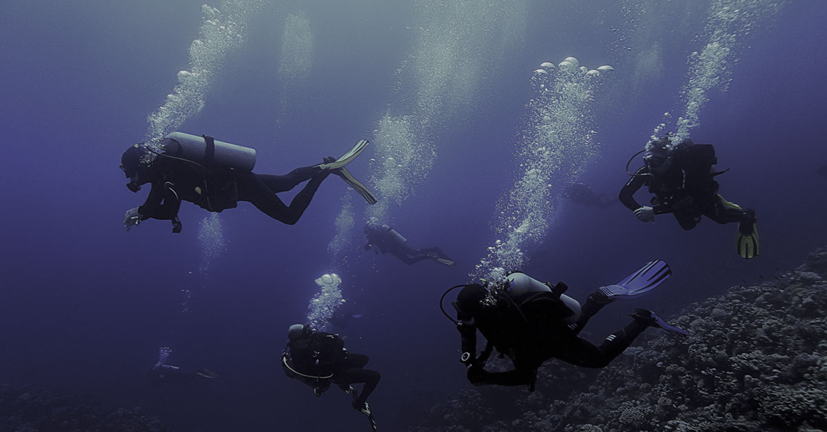 deep sea divers descending