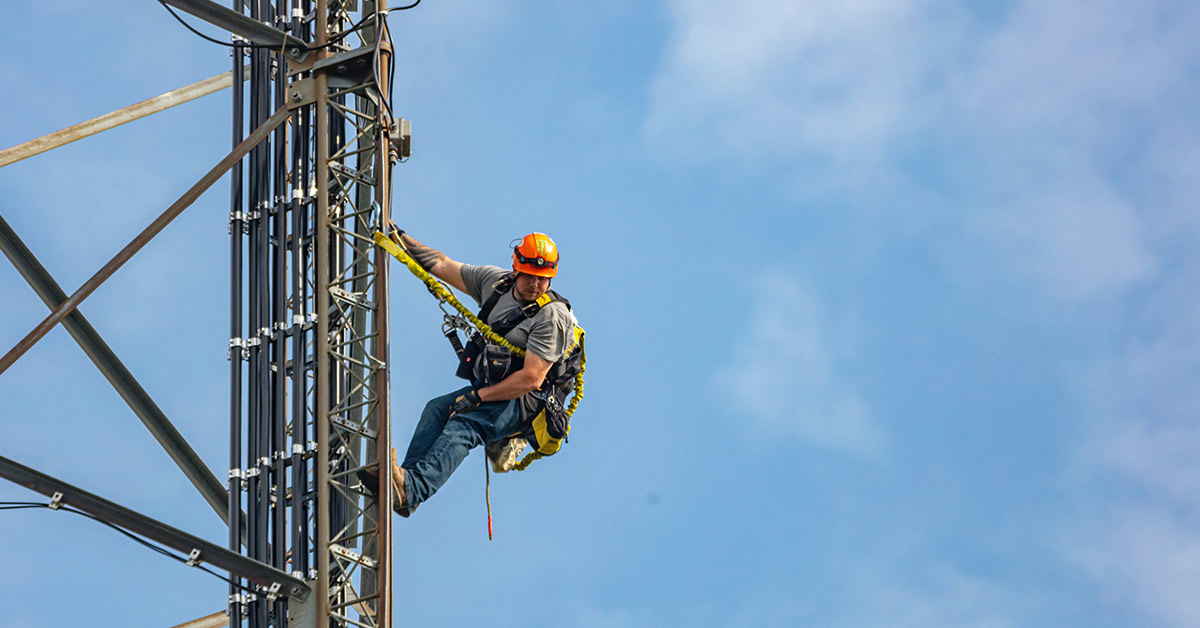 man climbing TV tower