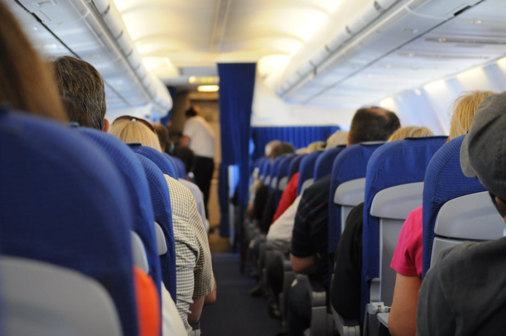 Should a Solo Plane Passenger give up their seat for a family?