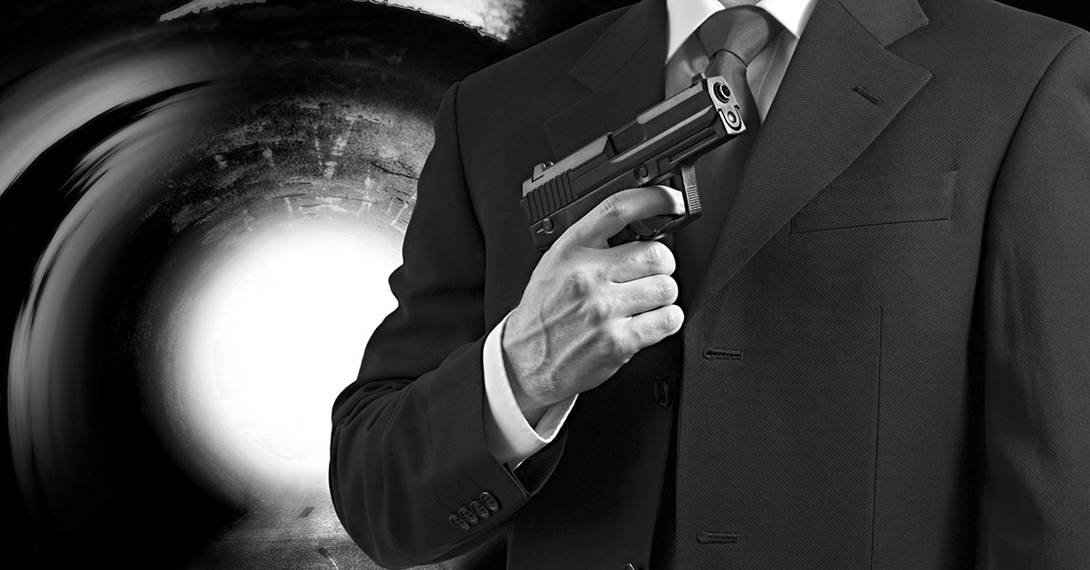 James Bond concept, black and white image, agent holding hand gun wearing black suit