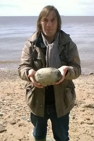 Man holding Ambergris on beach