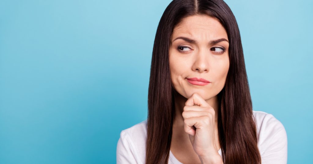 woman looking for answers on her questions while isolated with blue background