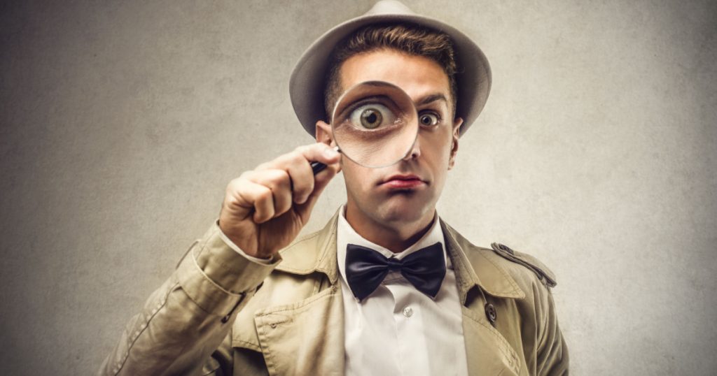 investigator looking with magnifying glass