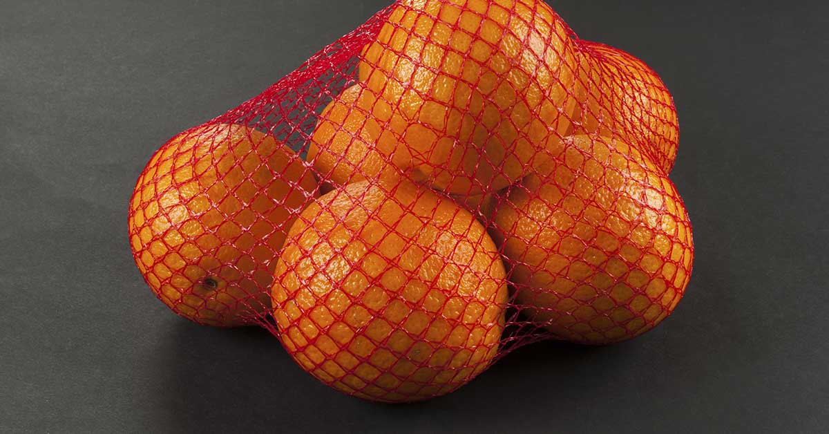oranges in red mesh bag