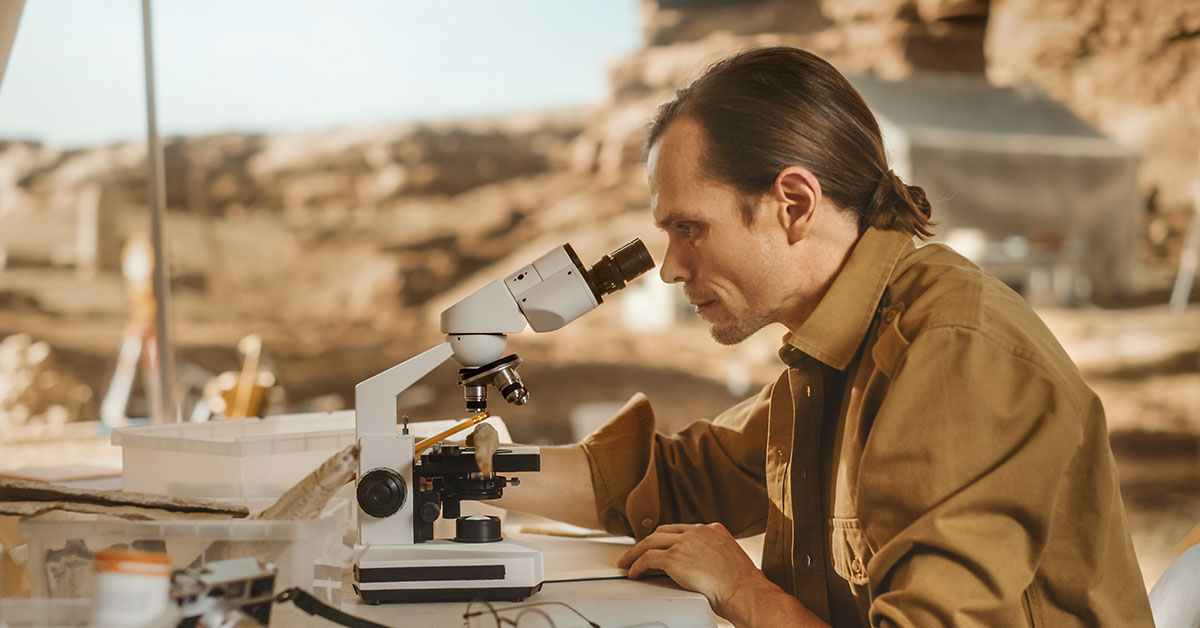 scientist using microscope