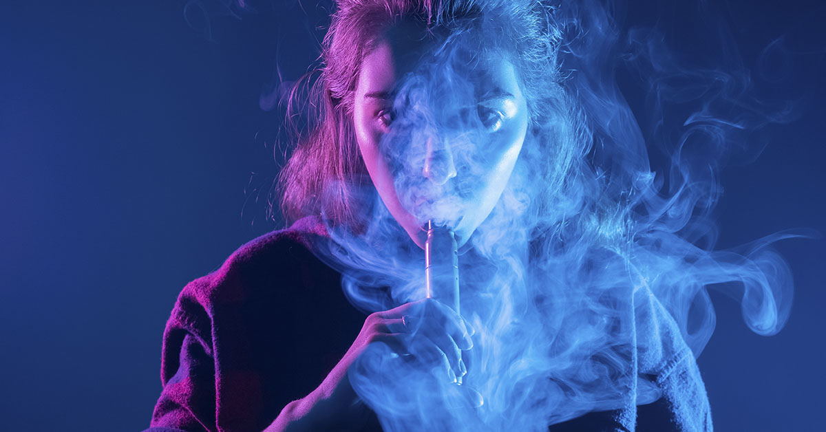 e-cargette concept. Woman vaping, pink and blue lights