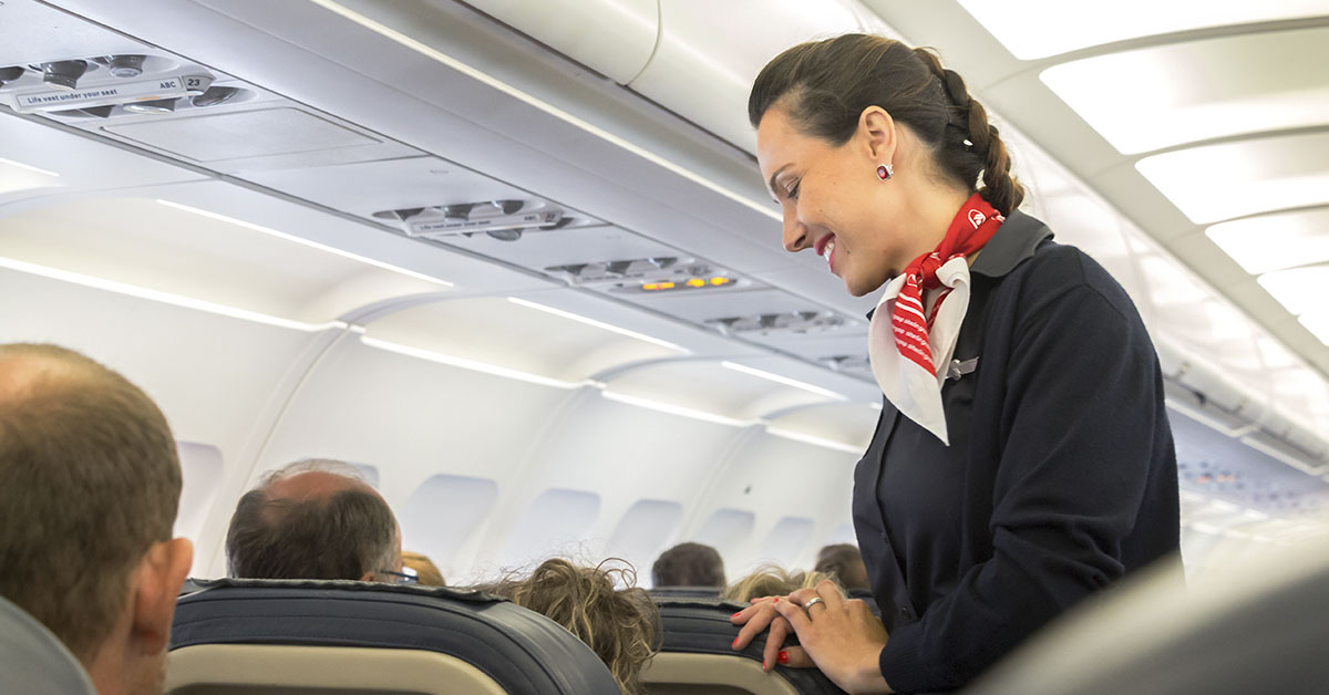 flight attendant attending to passengers