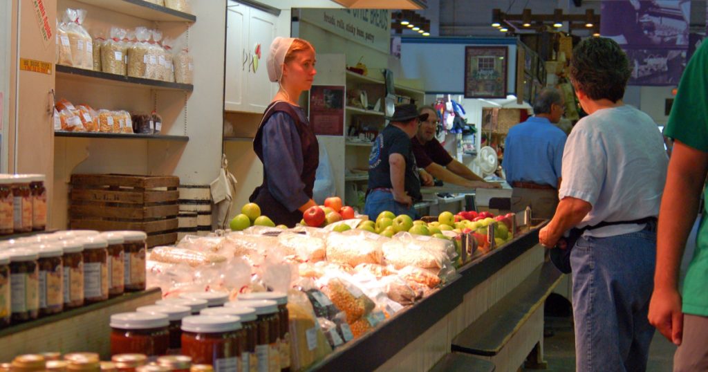 Lancaster, PA, USA September 18 A Mennonite woman minds an organic food stall in Lancaster, Pennsylvania
