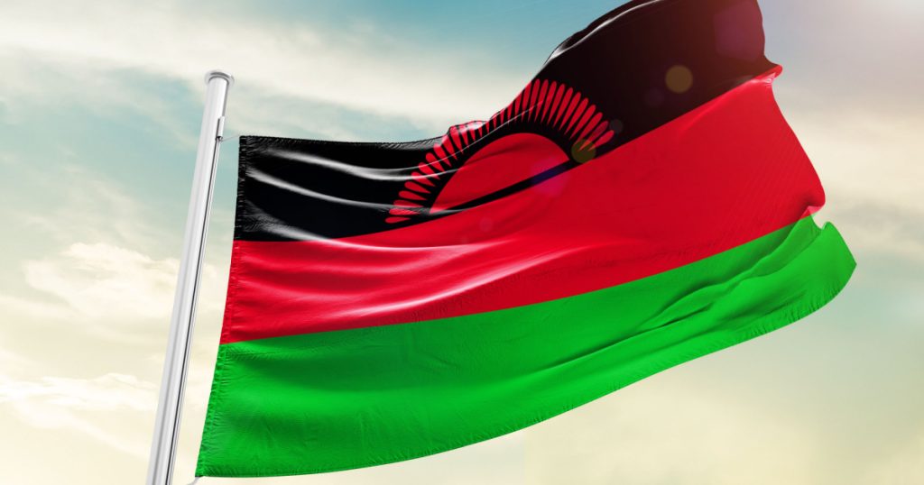 Malawi national flag cloth fabric waving on the sky - Image
