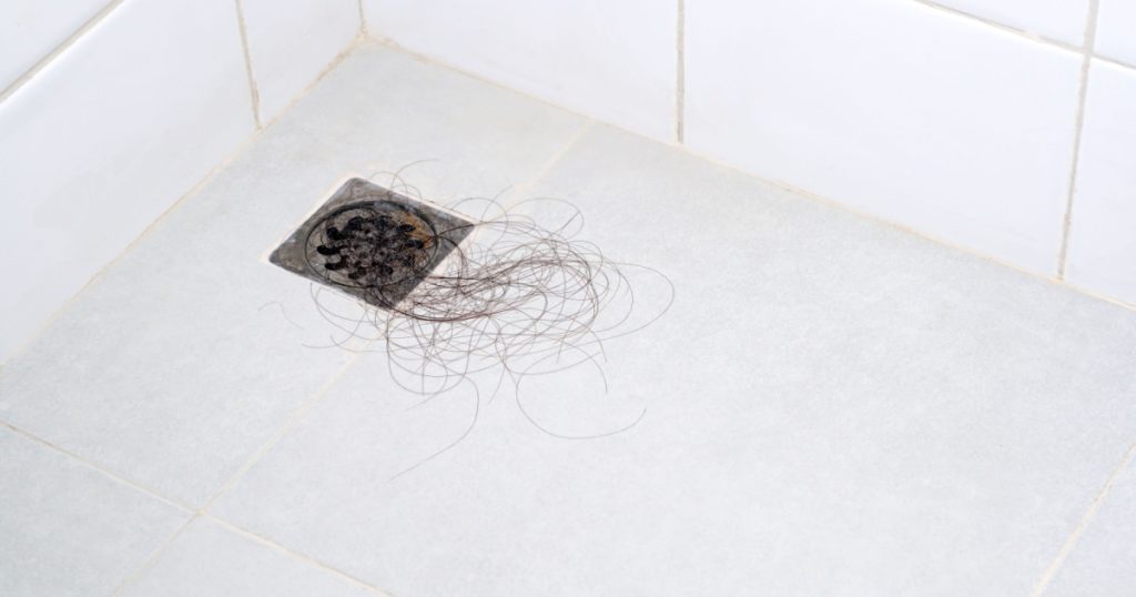 Pile of hair loss in a bathroom after wash hair.hair fall everyday serious problem, on white background.Solutions for hair loss.